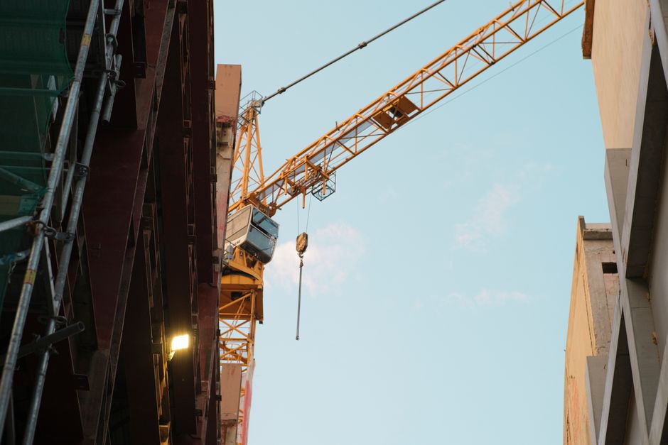 A construction crane dominates the urban skyline