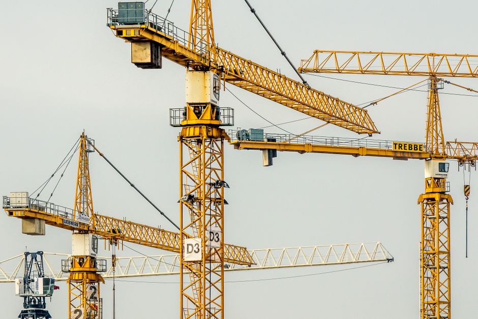 Cluster of yellow tower cranes at a construction site